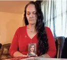  ?? EVERT NELSON/THE CAPITAL-JOURNAL ?? Amber Saale-Burger holds a photo of her late daughter, Kaylee Burger, in December as she shows a Save-a-Life Station. Burger overdosed from fentanyl in August, and Saale-Burger is fighting to help others in similar situations.