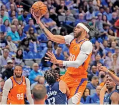  ?? — AP ?? Dallas Mavericks guard Jalen Brunson (second from left) defends as Phoenix Suns center JaVale McGee goes up to shoot during Game Four of their NBA basketball second-round playoff series in Dallas on Sunday.
