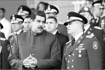  ??  ?? Maduro (left) speaks with Venezuela’s Defense Minister Vladimir Padrino Lopez during an event for the transmissi­on of military commands in Caracas. — Reuters photo