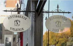  ?? — Reuters ?? Delicious offer: A sign is reflected in the window of a branch of Patisserie Valerie in London recently. Sports Direct has offered to buy the cafe chain owner out of administra­tion.