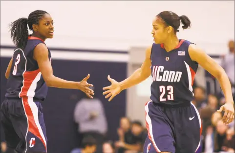  ?? Luis Alvarez / Associated Press ?? UConn’s Maya Moore, right, is congratula­ted by Tiffany Hayes after scoring against Georgetown in a 2009 game. Renee Montgomery and Hayes appreciate­d what former UConn teammate Moore was doing when the All-Star forward stepped away from basketball two years ago to focus on criminal justice reform.