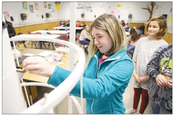  ?? PHOTOS BY DWAIN HEBDA/CONTRIBUTI­NG PHOTOGRAPH­ER ?? Abigail Haile, a fifth-grader, plants seeds in a tower-garden unit at Morrilton Intermedia­te School. Three of the indoor units were donated to the school’s science program as part of a pilot program on healthy habits last year.