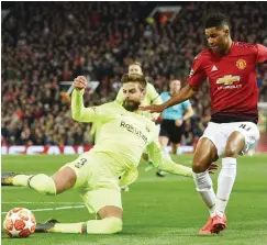  ??  ?? Barcelona FC defender Gerard Pique tackles Manchester United forward Marcus Rashford during the UEFA Champions League quart-final match