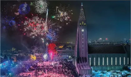  ?? ?? ROCKET FANS: Fireworks over Hallgrimsk­irkja church and beyond in Reykjavik on New Year’s Eve
