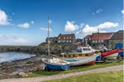  ??  ?? Craster, with its colourful fishing boats clinging to the sheltering harbour, known as The Haven.