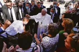  ?? Petr David Josek / Associated Press ?? Pope Francis blesses a man as he greets admirers during a walk around the piazza of the Cathedral of St. Martin in Bratislava, the capital of Slovakia.