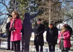  ??  ?? Mayor Lisa Baldelli Hunt stands beside a silhouette sculpture of the Rev. Martin Luther King Jr. as she speaks during Monday’s tribute at the King Memorial on Mason Street. In the background, from left, State Rep. Robert Phillips (D-Dist. 51,...