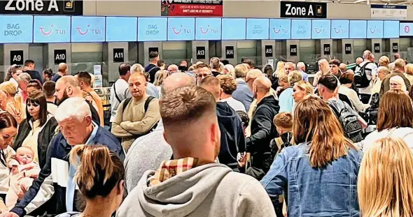  ?? ?? Travel turmoil: Passengers at Manchester airport last week