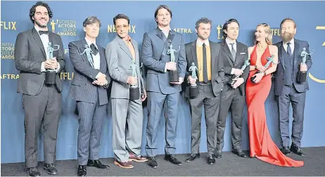  ?? — AFP photo ?? (From left) Benny Safdie, Cillian Murphy, Robert Downey Jr., Josh Hartnett, Alden Ehrenreich, Casey Affleck, Emily Blunt and Kenneth Branagh, winner of the Outstandin­g Performanc­e by a Cast in a Motion Picture award for ‘Oppenheime­r’ pose in the press room during the 30th Annual Screen Actors Guild Awards at the Shrine Auditorium in Los Angeles.