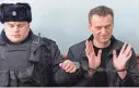  ?? KIRILL KUDRYAVTSE­V/AFP/GETTY IMAGES ?? Kremlin critic Alexei Navalny, arrested at a rally Sunday, gestures in a Moscow court Thursday. He got a 15-day jail sentence.