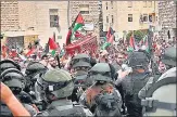  ?? AFP ?? Israeli security forces exercise force as Palestinia­n mourners carry the coffin of slain Al-jazeera journalist Shireen Abu Akleh out of a hospital, in Jerusalem.