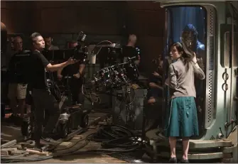  ?? Photo courtesy of Fox Searchligh­t Pictures ?? In this behind-the-scenes photo of “The Shape of Water,” Oscar winner for “Best Picture,” a camera closes in on actress Sally Hawkins and the sea creature. The film also garnered the Oscar for “Production Design,” and “Directing.” Daniel Kraus, the...