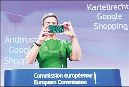  ??  ?? European Commission­er for Competitio­n Margrethe Vestager takes a picture as she arrives at a press conference on an antitrust case against US search engine Google at the European Commission in Brussels, on June 27. The EU slapped Google with a record...