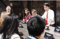  ??  ?? Chairing a discussion about machine learning with Prime Minister Justin Trudeau and others at Go North