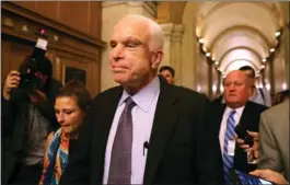  ?? JUSTIN SULLIVAN, GETTY IMAGES ?? Sen. John McCain is pursued by reporters after casting a “no” vote on Capitol Hill early Friday.