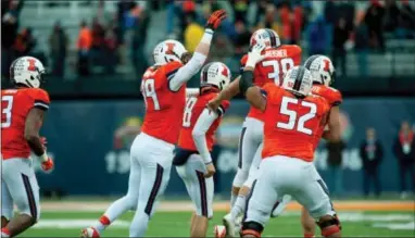  ?? BRADLEY LEEB — THE ASSOCIATED PRESS ?? Illinois kicker David Reisner (38) is mobbed by teammates after kicking the game-winning field goal in the closing seconds against Penn State on Saturday.