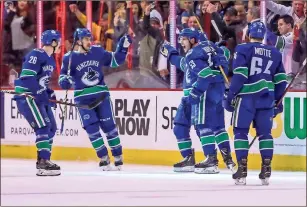  ?? / The Canadian Press -Ben Nelms ?? Vancouver Canucks’ Bo Horvat, second from right, celebrates his goal with teammates during a game against the Dallas Stars in Vancouver, British Columbia. Canucks team officials are envisionin­g a time in a few years when fans of Seattle’s new NHL franchise will make the trek north into downtown Vancouver to watch their team play the Canucks as part of a healthy rivalry.