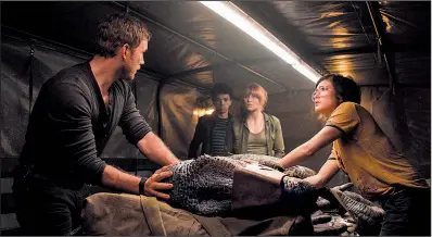  ??  ?? Owen (Chris Pratt), Claire (Bryce Dallas Howard), Franklin (Justice Smith) and Zia (Danielle Pineda) fight to save the life of hyper-intelligen­t Velocirapt­or Blue in Jurassic World: Fallen Kingdom.