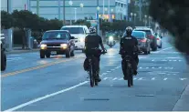  ?? L. TODD SPENCER/STAFF FILE ?? Virginia Beach bike police ride down Atlantic Avenue at the Oceanfront.