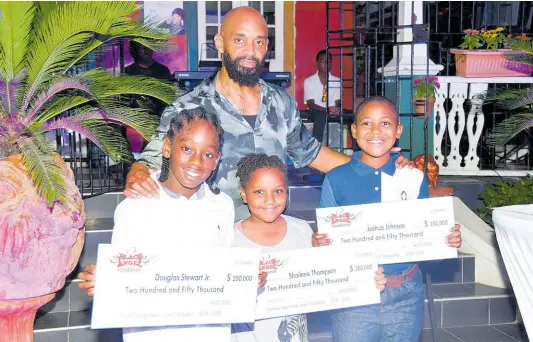  ?? CONTRIBUTE­D PHOTOS ?? Black Angel Foundation junior scholarshi­ps, sponsored by John Shop Records’ Duwayne John (back), were presented to recipients (from left) Douglas Stewart Jr from Mona Prep, Shailene Thompson from George Headley Primary, and Joshua Johnson from Liberty Prep.