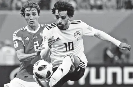  ??  ?? IT'S MINE. Russia's Mario Fernandes, left, challenges for the ball Egypt's Mohamed Salah, right, during the group A match between Russia and Egypt at the 2018 soccer World Cup in the St. Petersburg stadium in St. Petersburg, Russia, Tuesday, June 19,...