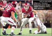  ?? PHOTO BY JASON IVESTER ?? Arkansas’ Brandon Allen slips past Texas A&M’s Daeshon Hall’s sack attempt.