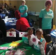  ?? PHOTO COURTESY LARRY ERDMAN ?? Children smile as they show off their artwork during the MLK Day of Service event in 2019at St. John Lutheran Church in Blue Bell.