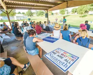  ?? APRIL GAMIZ/THE MORNING CALL ?? Jeff Brinks, top left, a pastor with St. John’s United Church of Christ in Nazareth, and Nazareth resident Karina Evans, bottom left, were among the speakers at the Nazareth Together rally Saturday in Nazareth Borough Park.