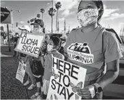  ?? SANDY HUFFAKER/GETTY-AFP ?? The Supreme Court ruled Thursday that the Deferred Action for Childhood Arrivals program will remain in place. Above, demonstrat­ors in San Diego show support for the ruling.