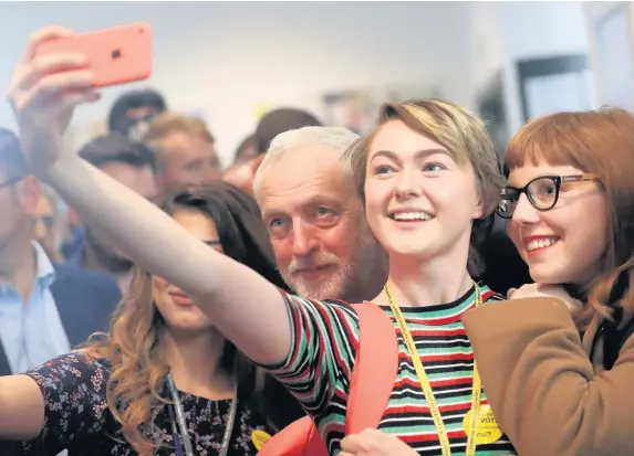  ??  ?? > Labour leader Jeremy Corbyn has a selfie taken with young supporters on the campaign trail last month