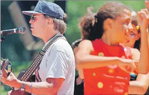  ?? AP PHOTO ?? In this June 21, 1997, file photo, Country Joe McDonald, left, an anti-Vietnam War protester and 1960s rock icon, sings “Carry On,” a healing song of peace, during San Francisco’s 30th anniversar­y celebratio­n of the “Summer of Love.”