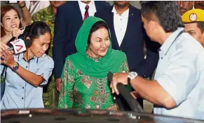  ??  ?? Done at last: Rosmah smiling at reporters as she leaves the MACC building.