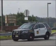  ?? PETE BANNAN - DIGITAL FIRST MEDIA ?? A police car leaves the George W. Hill Correction­al Facility in Thornbury Township.