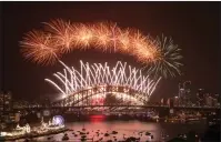  ??  ?? Fireworks light up the sky above Sydney Harbour
