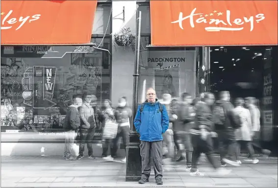  ??  ?? Heartbroke­n Jock waits outside Hamleys toy store in London, where there was a potential sighting of his wife Karen on October 17