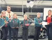  ??  ?? The Third Upton Priory Scouts get their donations from Audi Macclesfie­ld