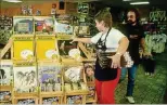  ?? MELISSA MIMMS/THE PALM BEACH POST ?? CLOCKWISE FROM TOP LEFT: 1986: An employee stocks the display of the new Bruce Springstee­n album at the Peaches Records & Tapes on Okeechobee Boulevard. Back then, the release of a major artist’s new album was big news, as people would flock to the...