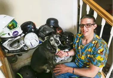  ??  ?? McClintock (with his dog Nemo) and all his helmets. When he sees people – especially kids – cycling or skateboard­ing without a helmet, he will give them one or give them money to buy one.