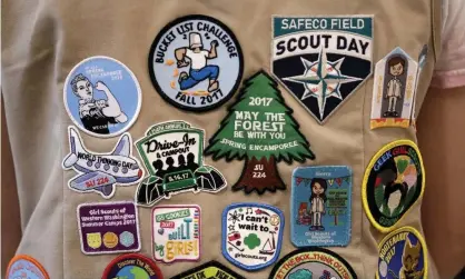  ??  ?? Patches cover the back of a Girl Scout’s vest at a demonstrat­ion of some of their activities inSeattle. Photograph: Elaine Thompson/AP