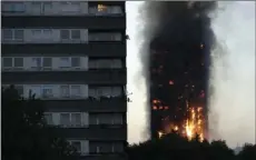  ?? AP PHOTO/MATT DUNHAM ?? Smoke and flames rise from a building on fire in London on Wednesday.