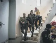  ?? PICTURE: AP. ?? CAPTURED: Iraqi security forces drag a suspected ‘Islamic State’ fighter down a spiral staircase after raiding his house in the liberated eastern part of Mosul.