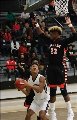  ?? Terrance Armstard/News-Times ?? District basketball tournament­s: Smackover's Roshard Boone pump fakes Warren's Treylon Burks off his feet while going in for a basket in action this season. The Buckaroos will host the Junior High and Senior District Tournament­s, beginning on Monday....