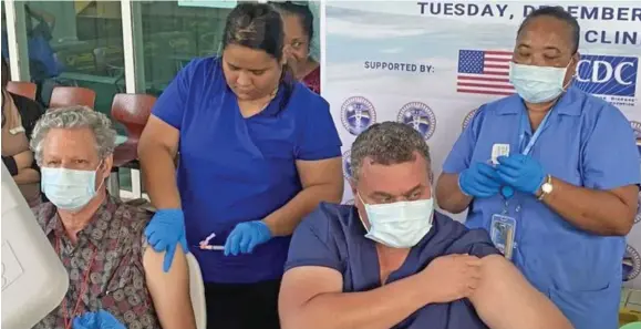  ?? Photo: RNZ Pacific ?? Marshall Islands Health Secretary Jack Niedenthal, left, and Public Health Director Dr Frank Underwood received Covid vaccines in Majuro recently from public health nurses Mineko Mista and Rosabella Jennet.