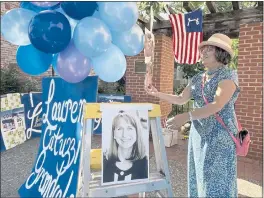  ?? PHOTOS BY SHERRY LAVARS — MARIN INDEPENDEN­T JOURNAL ?? Local artist Kimberly Rodler of San Rafael decorates Lauren Place with balloons, posters and photos of Lauren Grandcolas in San Rafael on Saturday. Grandcolas of San Rafael, was a passenger on hijacked United Flight 93 that crashed in Pennsylvan­ia.