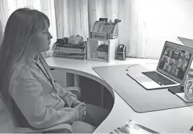  ?? BURKE BURNETT VIA AP ?? Kaimuki Middle School eighth grader Anastasiya Kamaletdin­ova sits in front of a computer for school in her bedroom in Honolulu. Like many Hawaii public school students, she’s spending the first day of school online as coronaviru­s cases surge, mostly on the island of Oahu, where Honolulu is located.