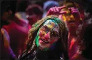  ?? (AP/Anupam Nath) ?? A girl smeared with colors celebrates Holi on Wednesday on a street in Guwahati.