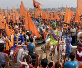  ?? — PTI ?? Artistes raise flags and dress up in costume of Chhatrapat­i Shivaji as they celebrate Shivaji Jayanti in Surat on Monday.