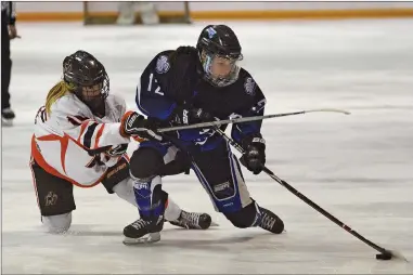  ?? STEVEN MAH/SOUTHWEST BOOSTER ?? Madison Garrett (right) got a shot on goal despite the slash of a Prince Albert Bears forward during a 5-4 loss on Saturday.