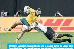  ??  ?? SAPPORO: Australia’s hooker Silatolu Latu is tackled during the Japan 2019 Rugby World Cup Pool D match between Australia and Fiji at the Sapporo Dome in Sapporo yesterday. —AFP