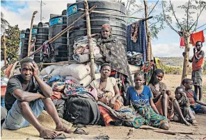  ??  ?? People displaced by the Mozambican conflict wait at a resettleme­nt area near Cabo Delgado
